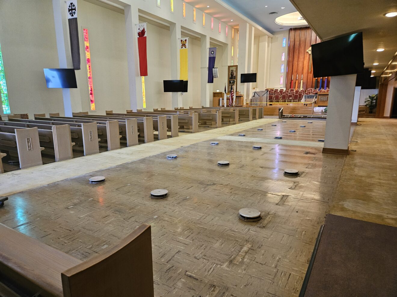 Removal of old carpet has begun. New flush covers for air intake and painting of pews to come.